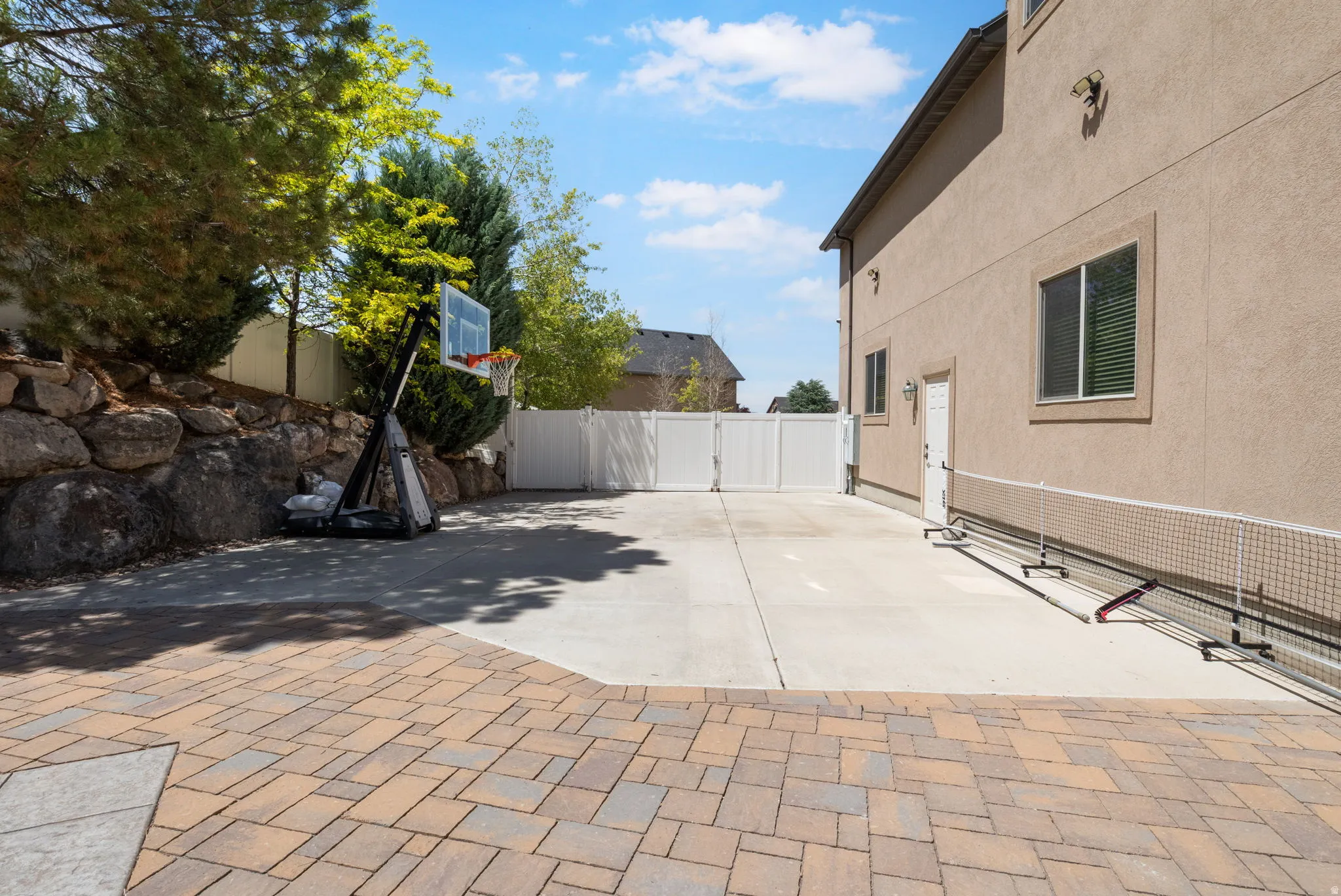 Enjoy the large concrete patio perfect or pickleball, basketball or more recreational toy storage.
