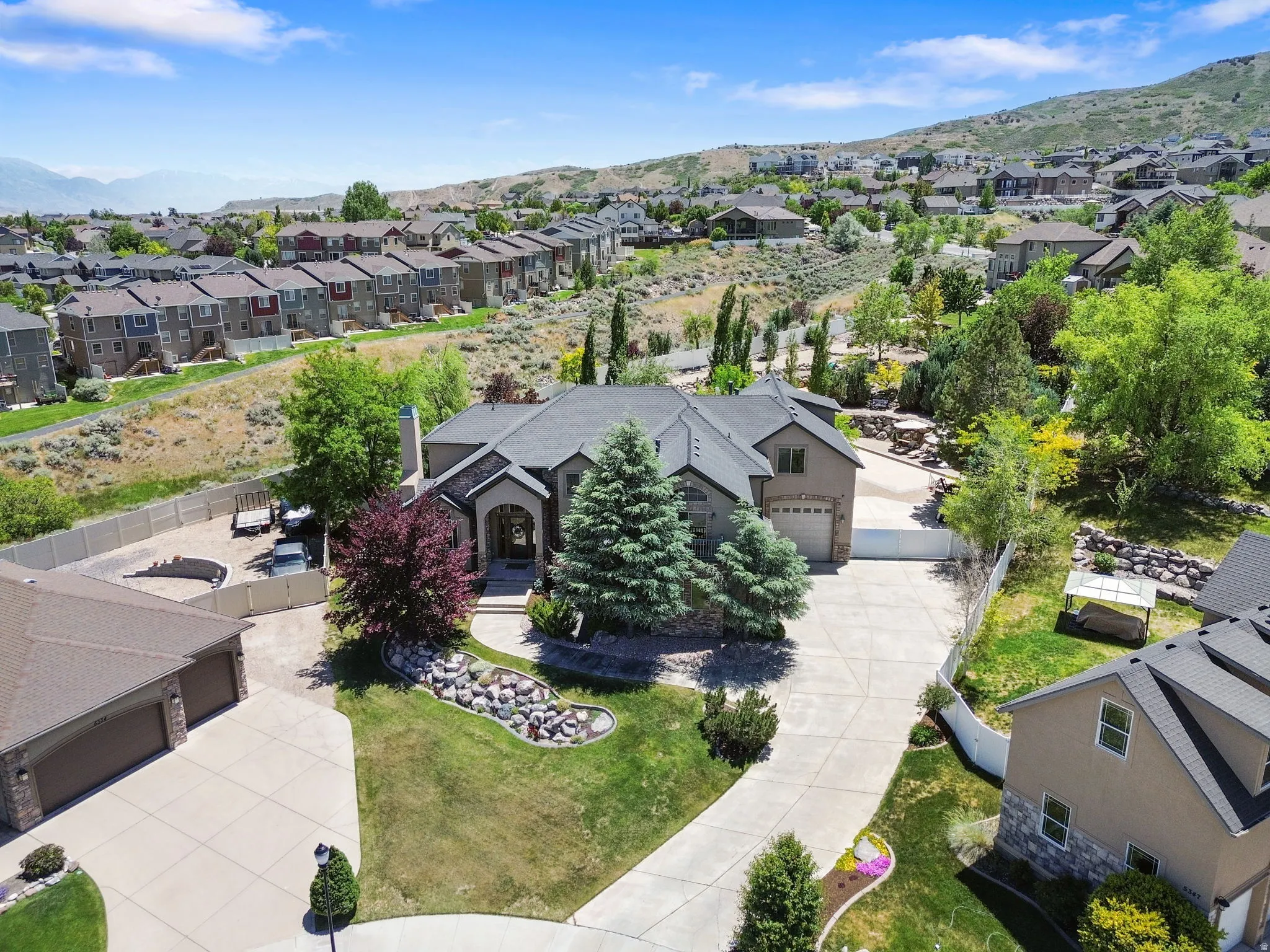 Large private driveway to a 3 car garage including RV garage with boat and concrete storage on the side.