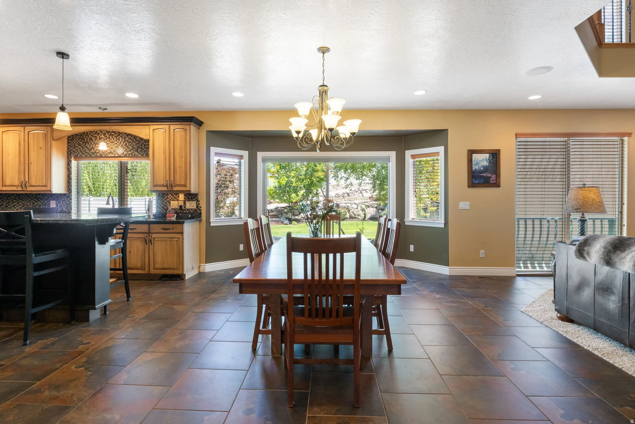 Open-concept living area with large sliding glass door to covered patio.