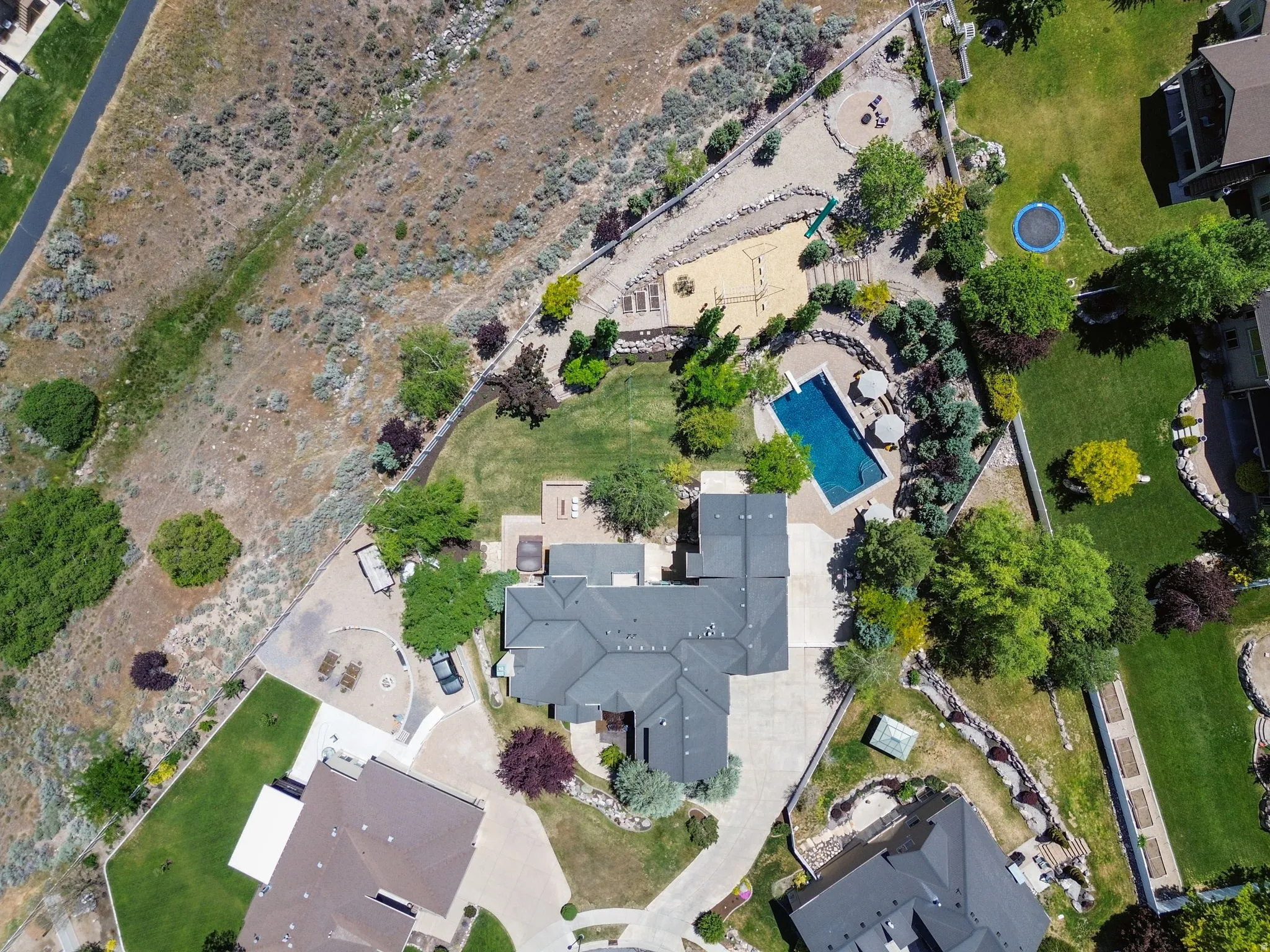 Expansive property featuring a large salt water outdoor swimming pool, multiple tiered entertainment spaces and 1000+ square feet patio space.