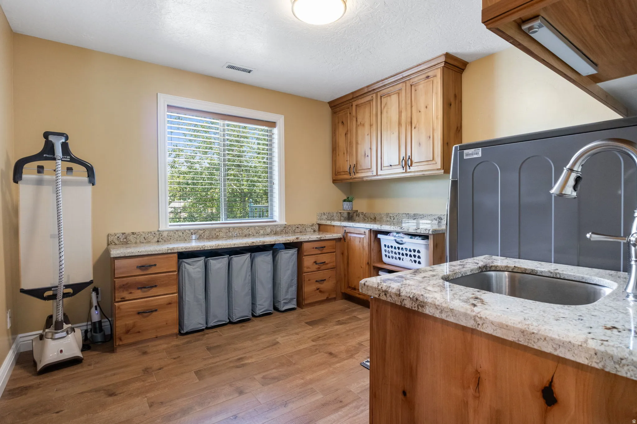 Large laundry that has been fully upgraded with custom storage.