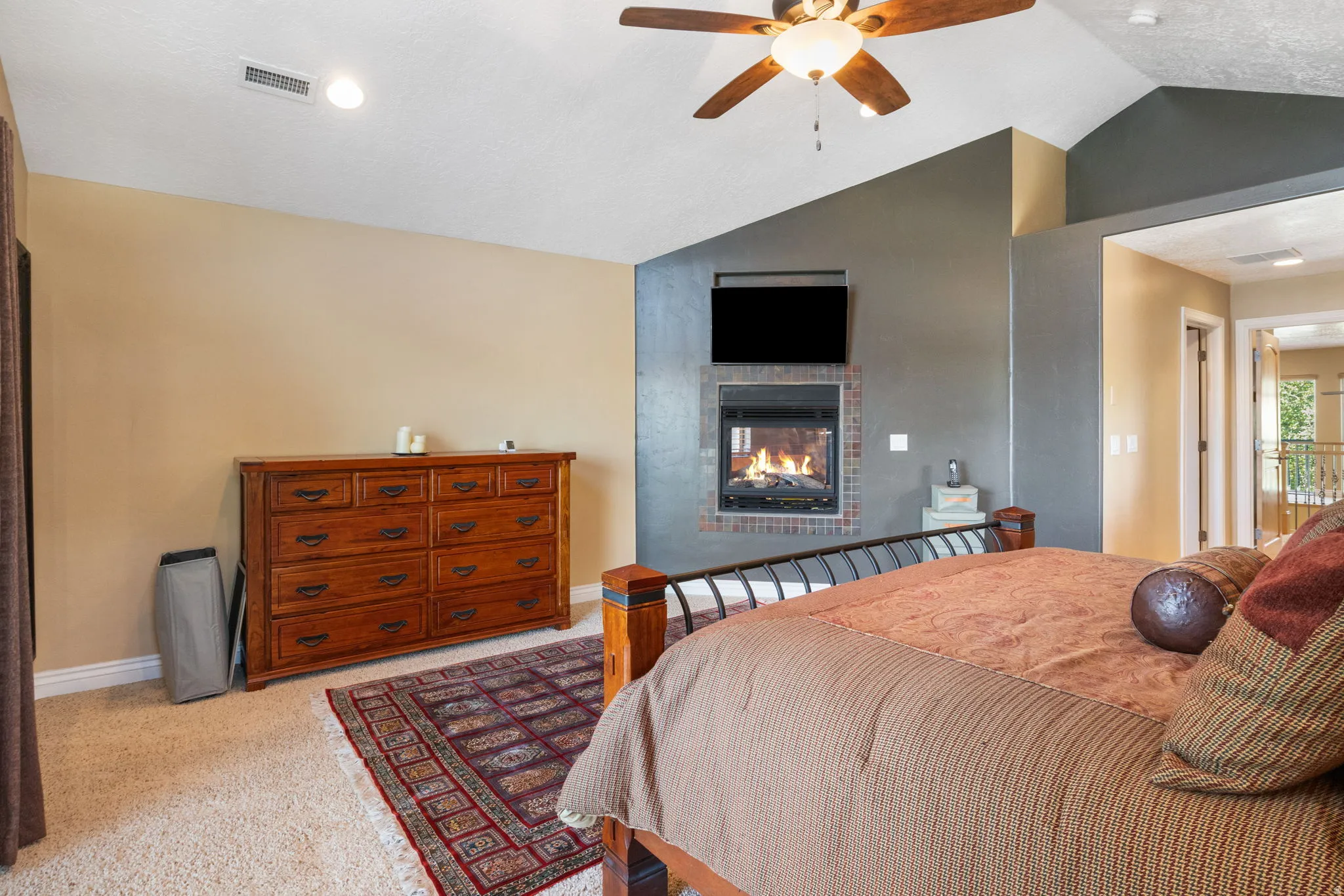 Vaulted ceilings and fireplace in primary suite.