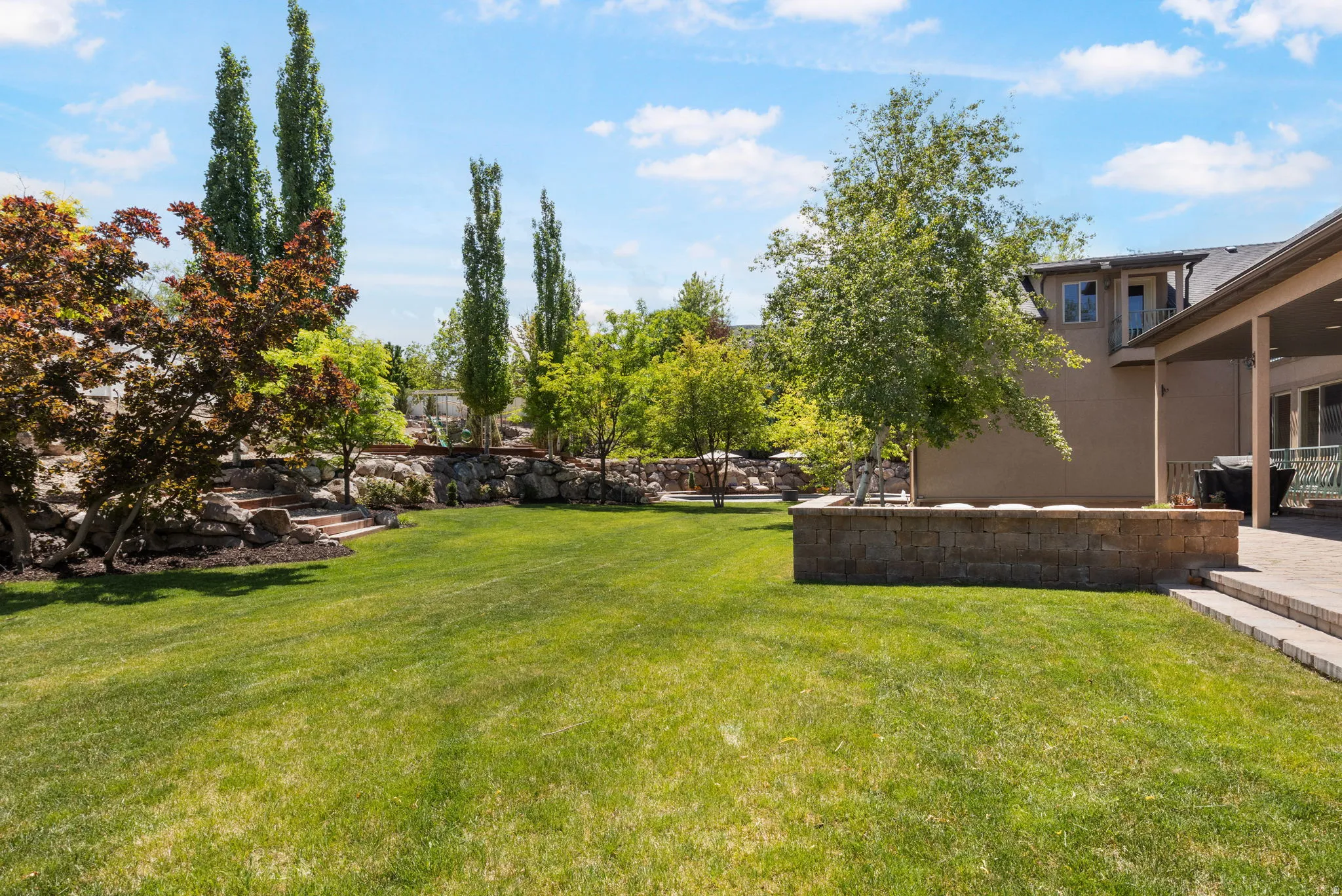 Expansive green lawn with tiered landscaping