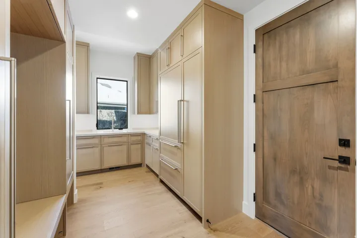 Custom cabinetry and integrated appliances define this space