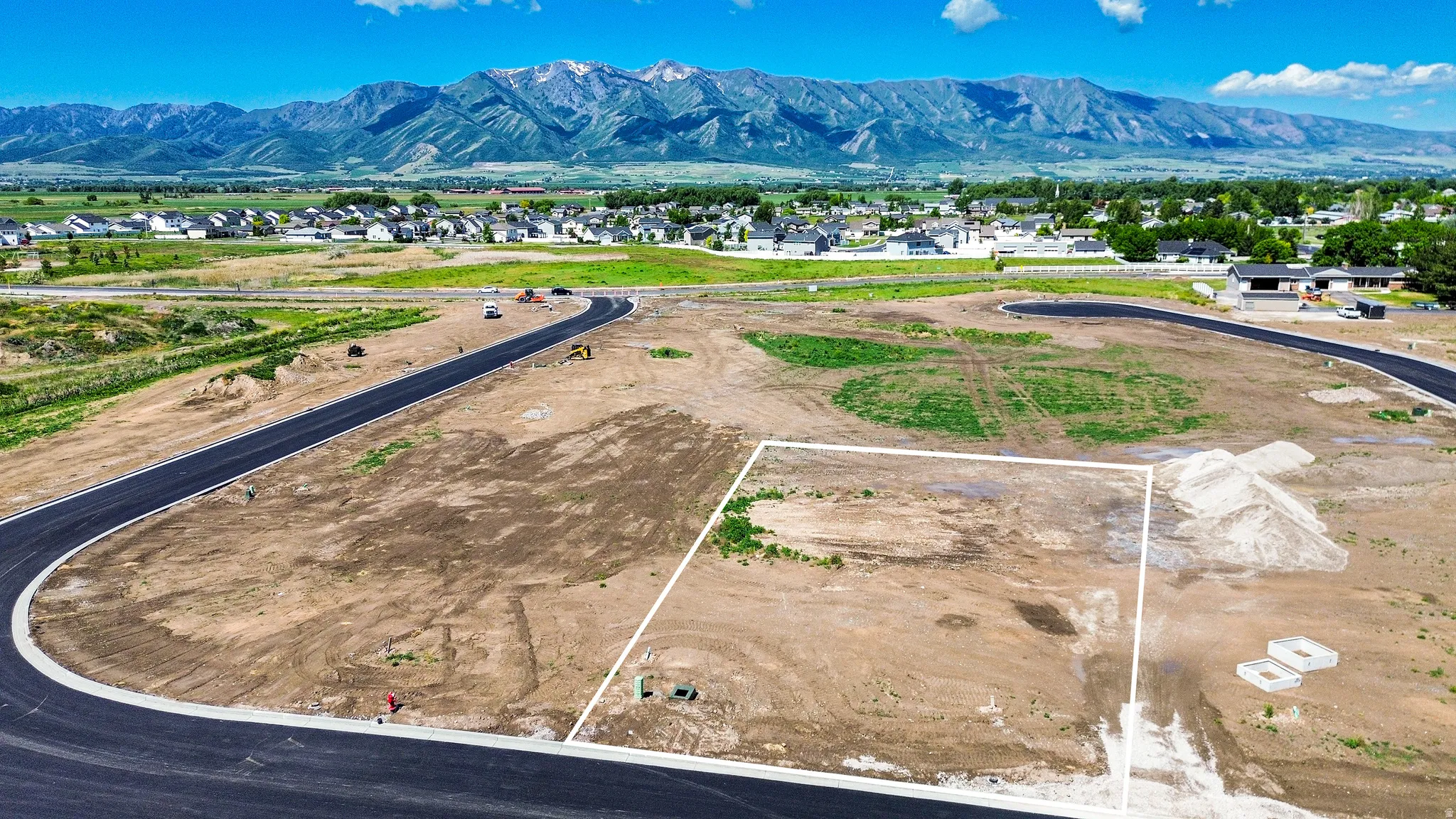 Cleared building lot with mountain backdrop