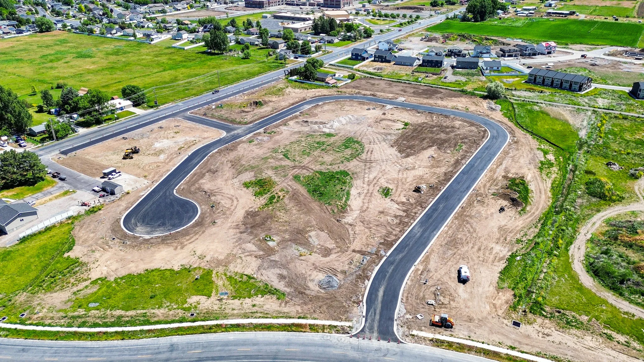 New development parcel featuring newly paved roadways and graded lots