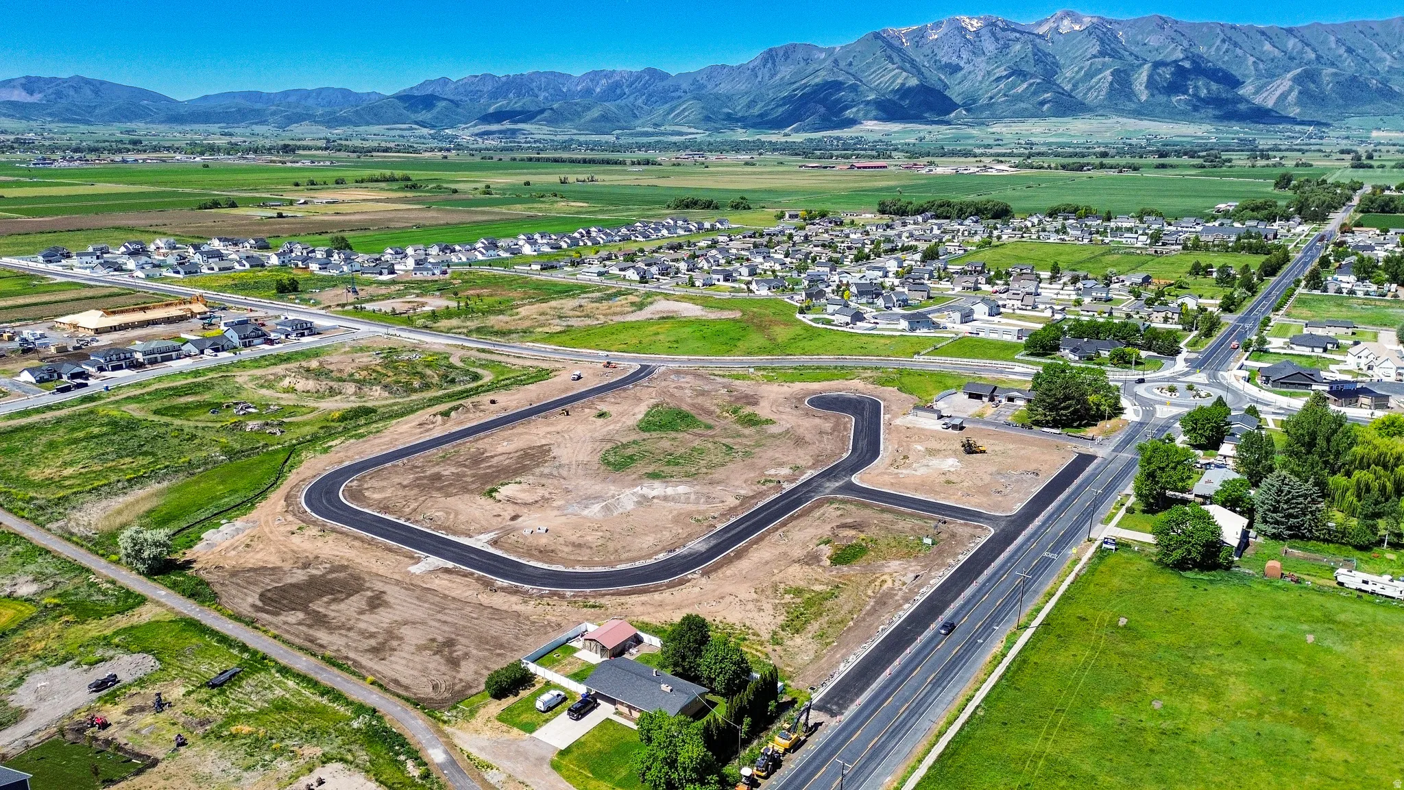 Developing land parcel featuring newly paved roadways and cul-de-sacs