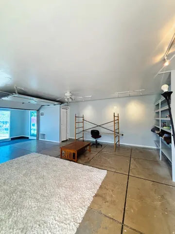 Spacious interior with concrete flooring and light-toned walls