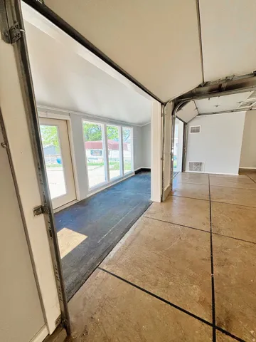 Bright interior space featuring a wall of windows and an exterior door with glass panels