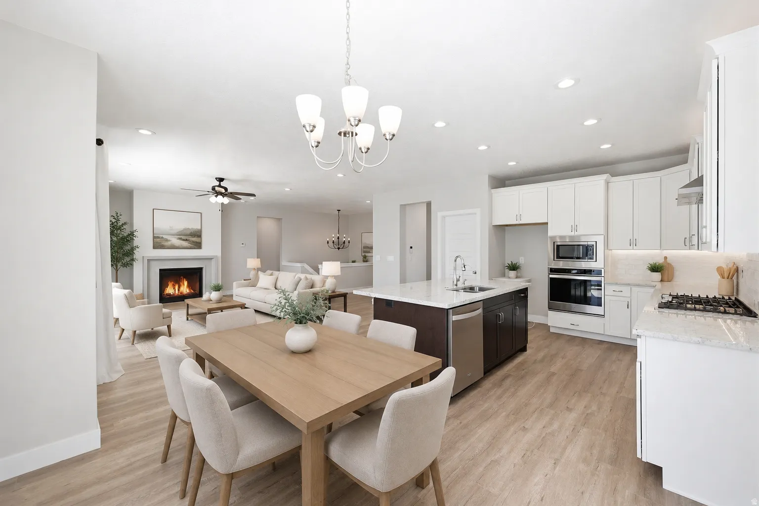 Open-concept living space featuring a dining area, kitchen, and living room