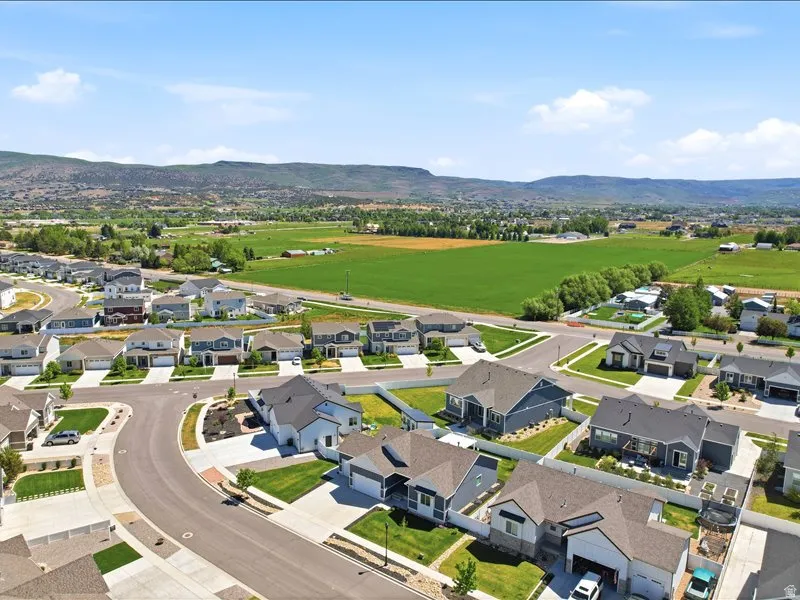 Newly developed residential area featuring paved streets and manicured lawns