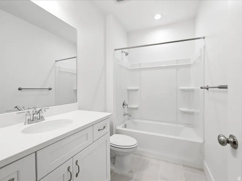White bathroom featuring a single vanity with an integrated sink, polished chrome faucet, and white cabinet doors with dark hardware