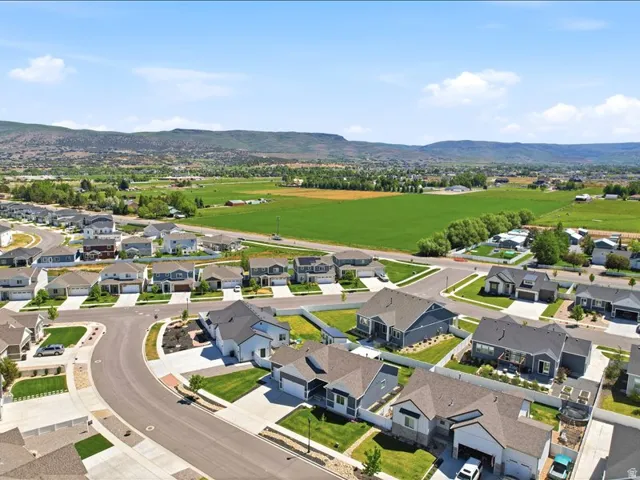 Newly developed residential area featuring paved streets and manicured lawns