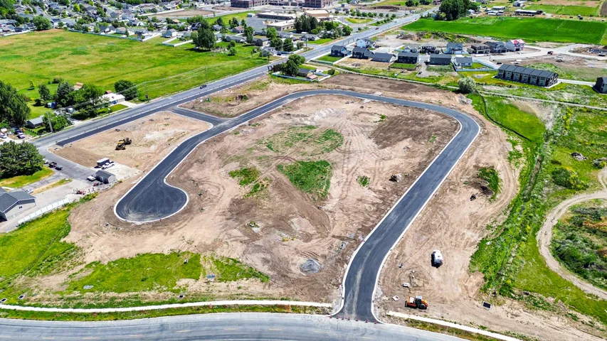 New development parcel featuring newly paved roadways and graded lots