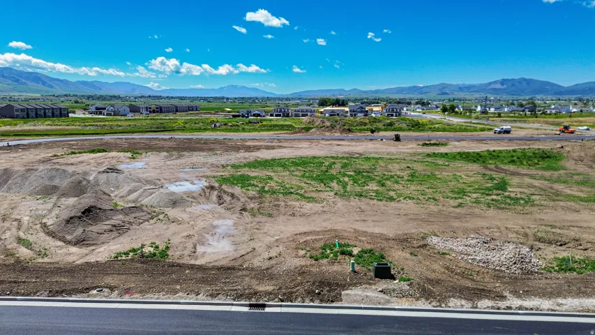 Expansive developable land featuring a clear-sky backdrop and distant mountain ranges