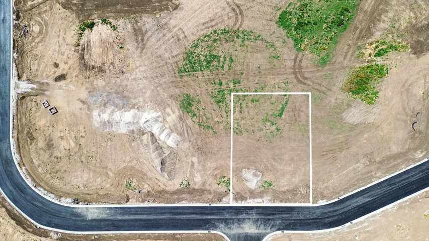 Developed lot with clear boundaries and partial green growth
