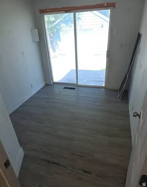 Room with wood-finish flooring and a sliding glass door