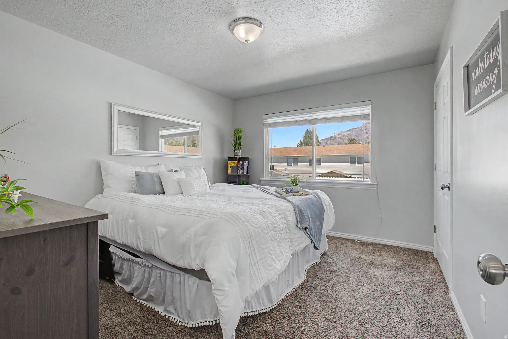 Neutral gray painted walls with white trim and a coordinating neutral carpet