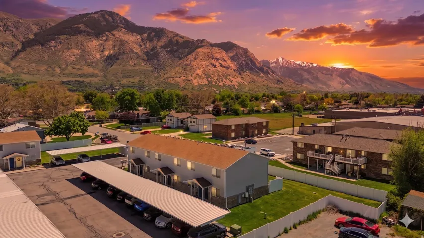 Expansive mountain scenery framing a residential area with multiple apartment buildings