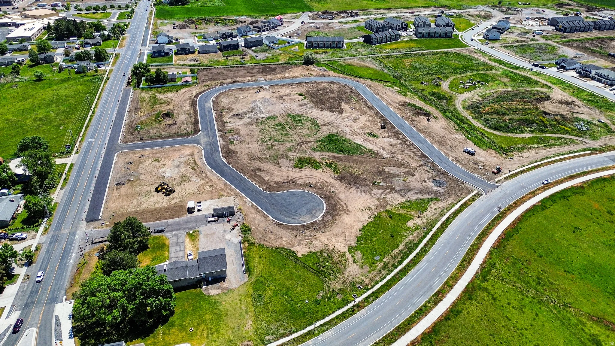 Aerial perspective showcasing newly paved roads and developed residential plots within an expansive land parcel