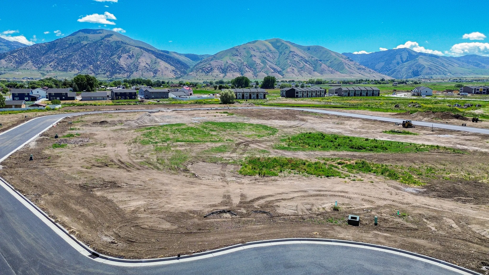 Developing lot with paved street frontage and mountain scenery