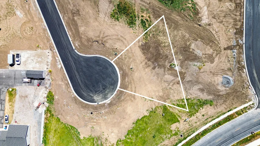Land parcel featuring a cul-de-sac entry, paved road access, and utility connections