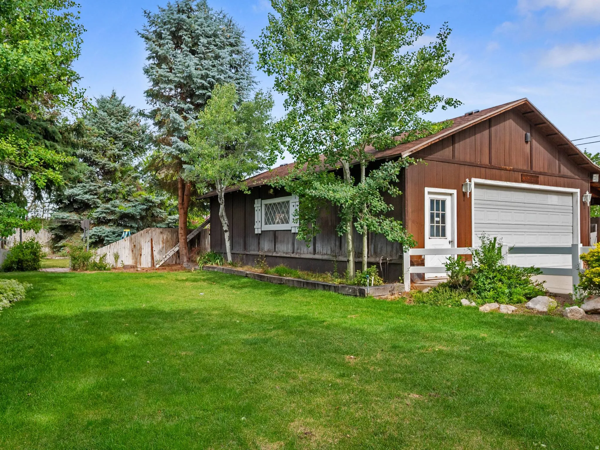 Another view of the backyard and large detached garage.