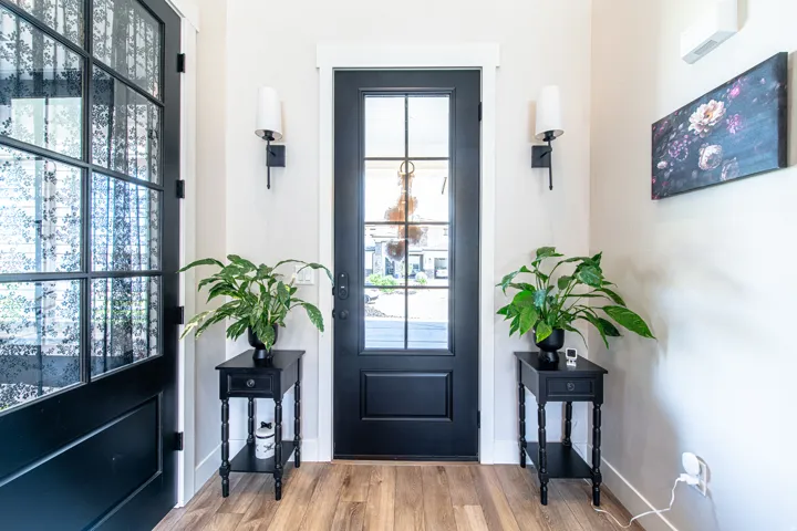 Entryway featuring a black paneled door with clear glass lites and a matching sidelight