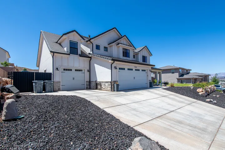Modern stucco and board-and-batten exterior with stone accents