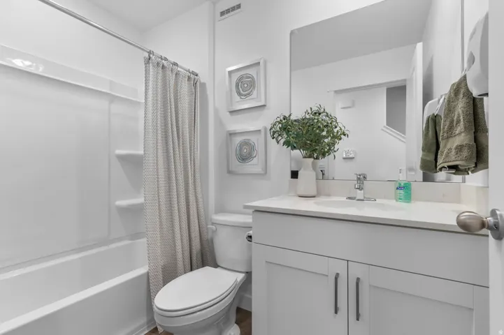 Bathroom featuring a white vanity with a light-colored countertop and undermount sink