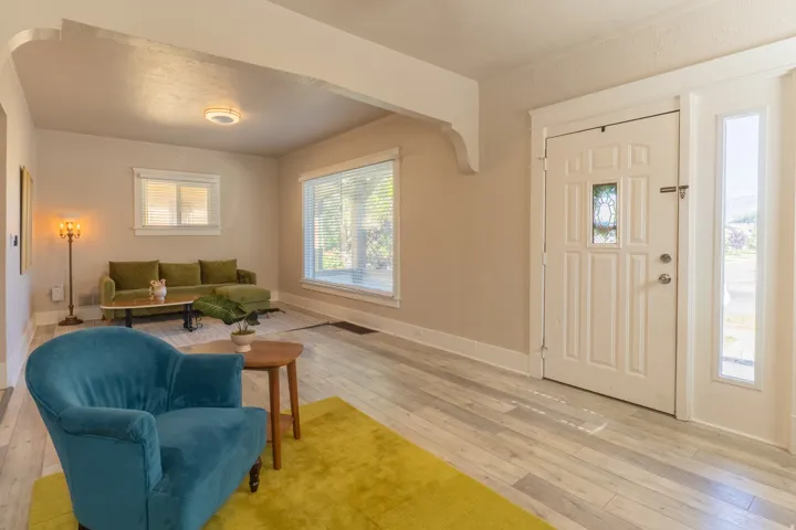 Entryway featuring a white paneled door with decorative glass inserts and a sidelight