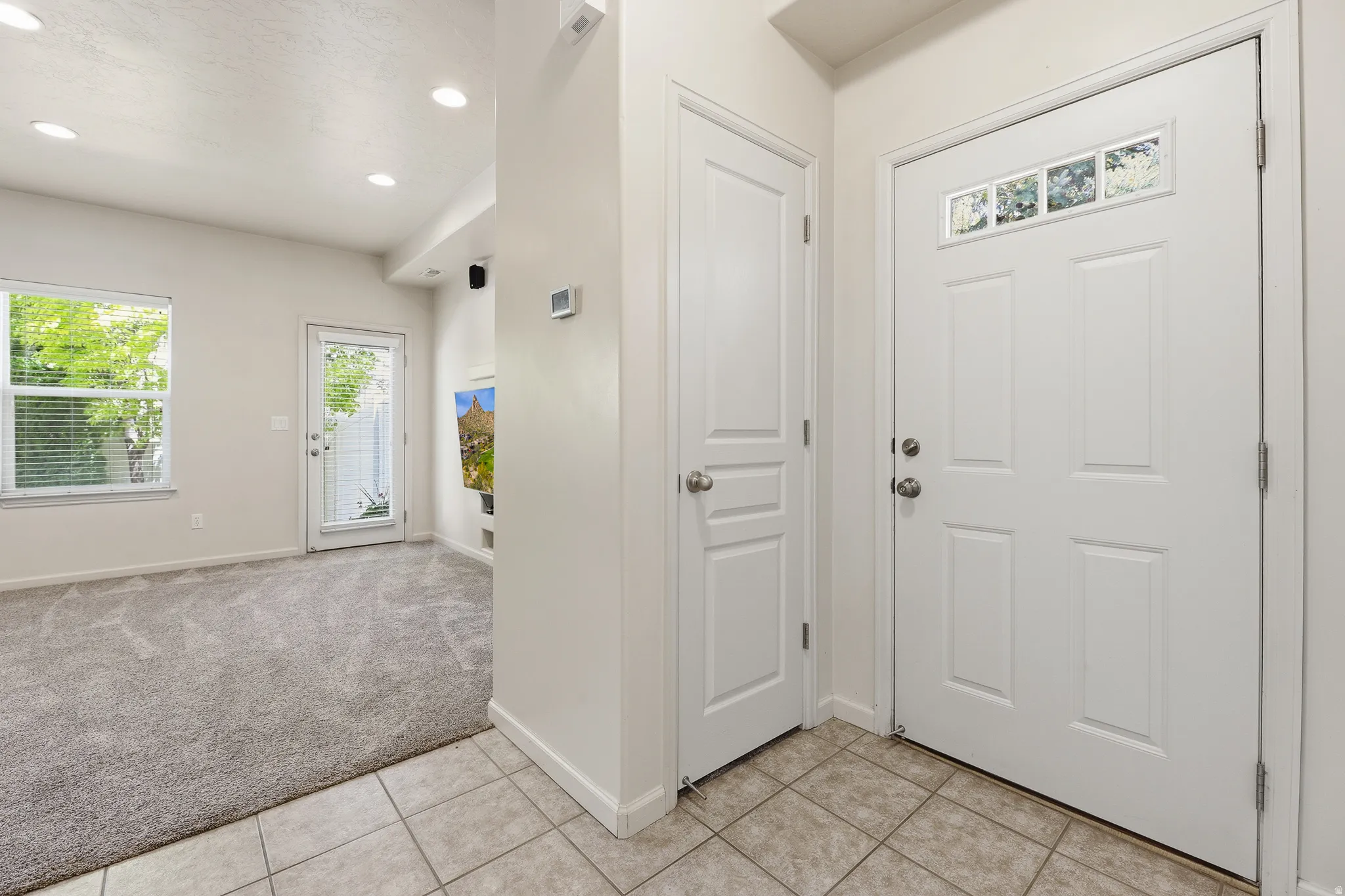 Entryway featuring ceramic tile flooring and a paneled door with decorative glass inserts