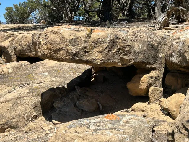 Natural rock outcropping featuring a recessed cave-like opening