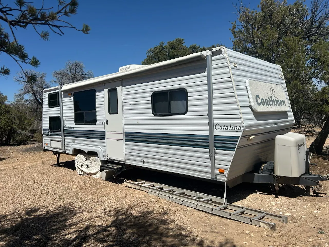 Coachmen Catalina travel trailer with white and blue striped exterior