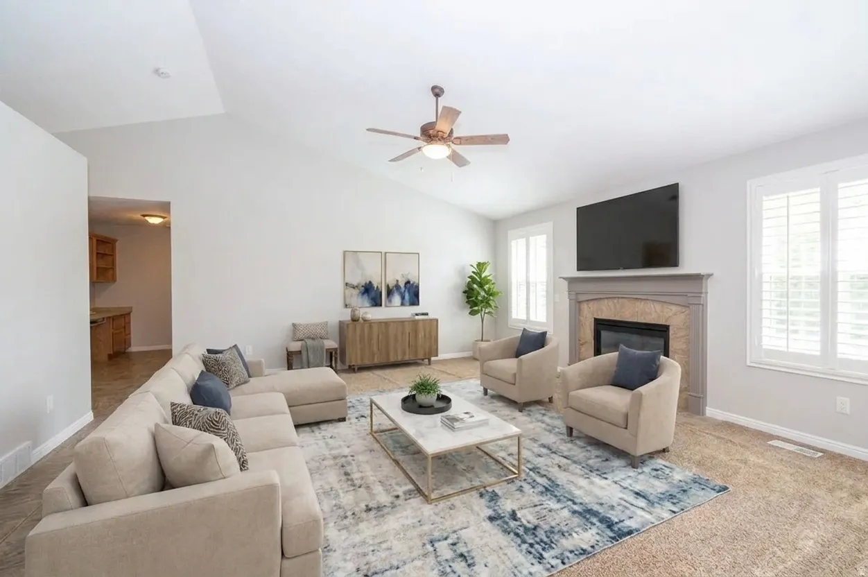 Vaulted ceilings, a built-in fireplace with a stone surround, and plantation shutters