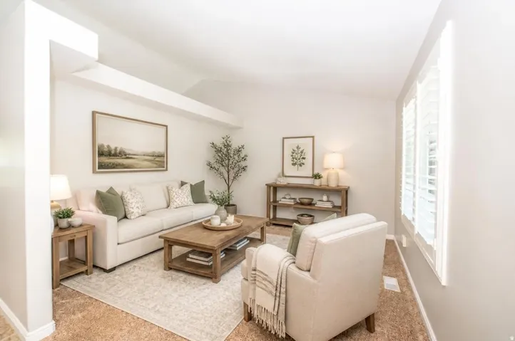 Vaulted ceiling, white plantation shutters, light-toned walls, and wood-finish flooring