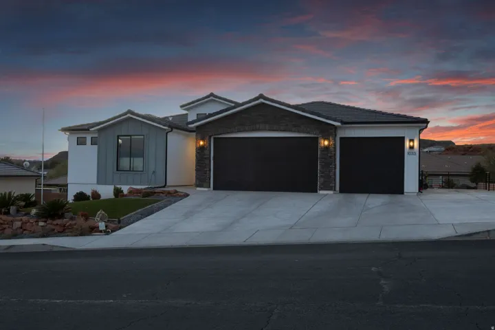 Contemporary two-story residence featuring a stone and vertical siding facade
