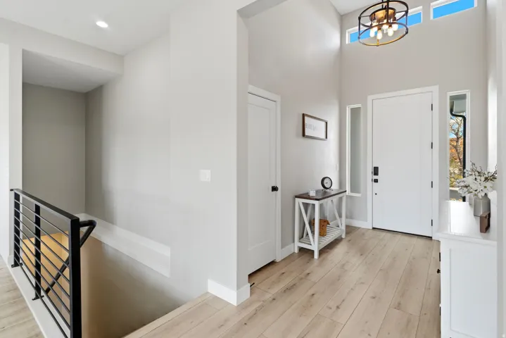 Light wood-finish flooring extending from the entryway into the interior