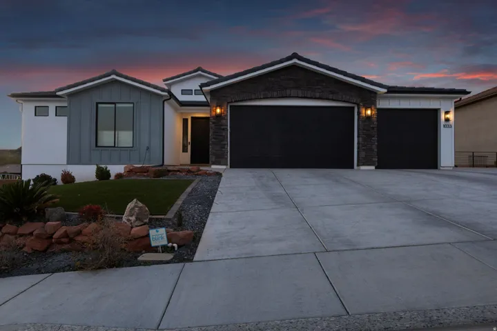 Contemporary architectural style featuring a multi-textured facade with stone accents and vertical siding