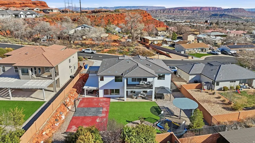 Two-story residence featuring a gray tile roof and white exterior siding