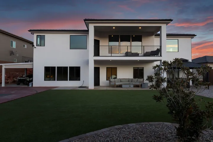 Modern stucco exterior with a large artificial turf lawn
