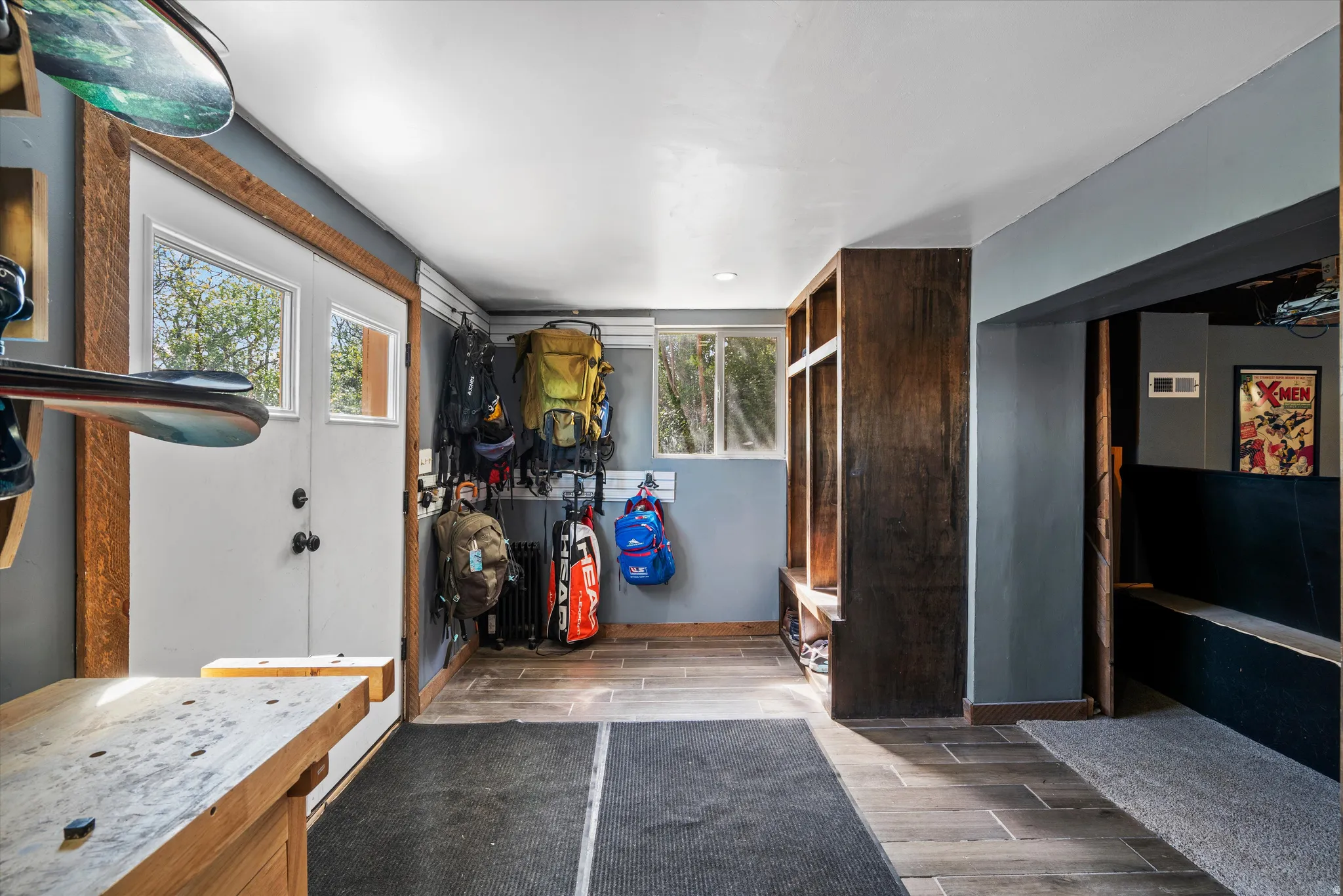 Entryway featuring wood-finish flooring and a built-in storage bench