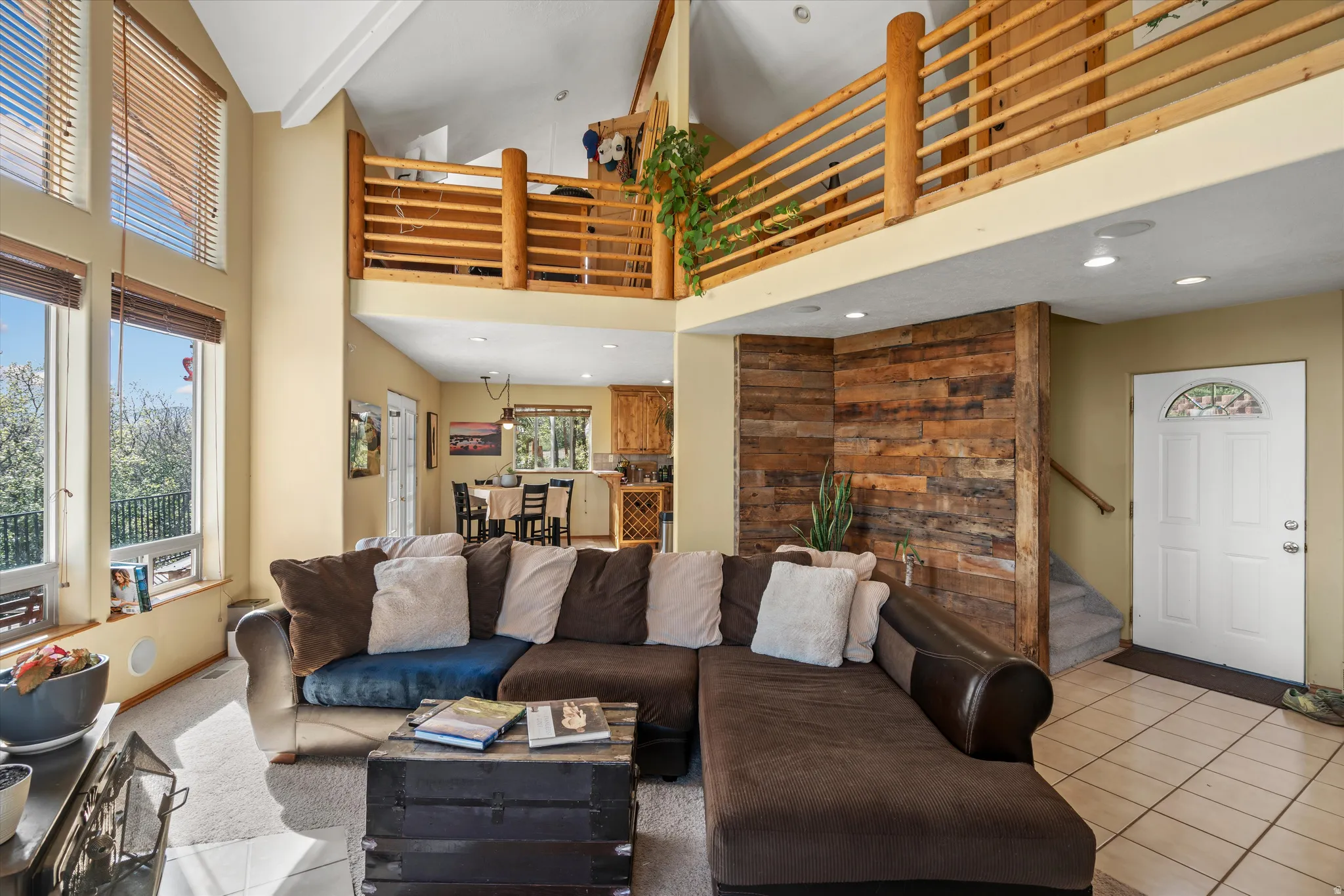 Vaulted ceilings with a wood-finish balcony overlook