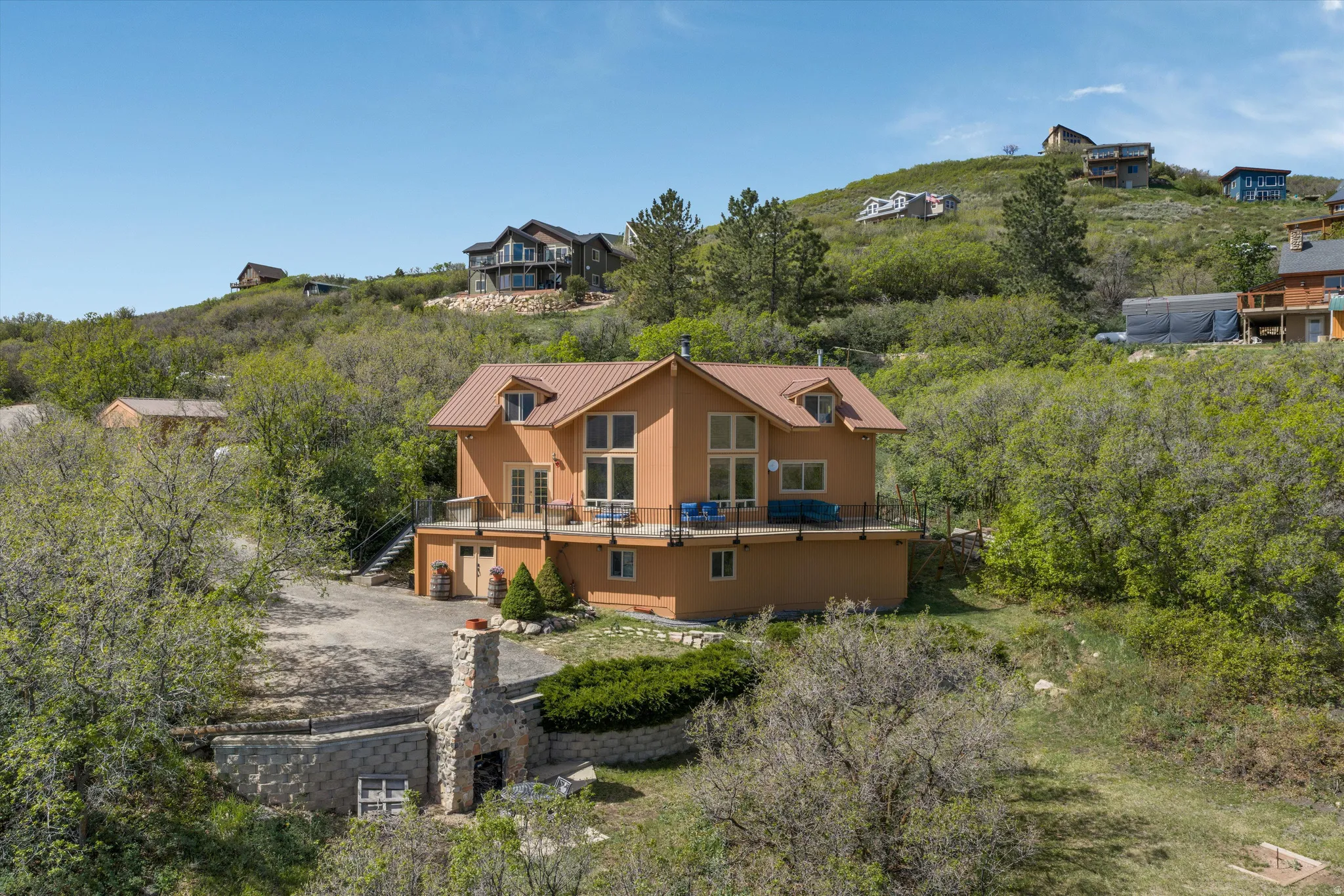 Terracotta-colored stucco exterior with a metal roof