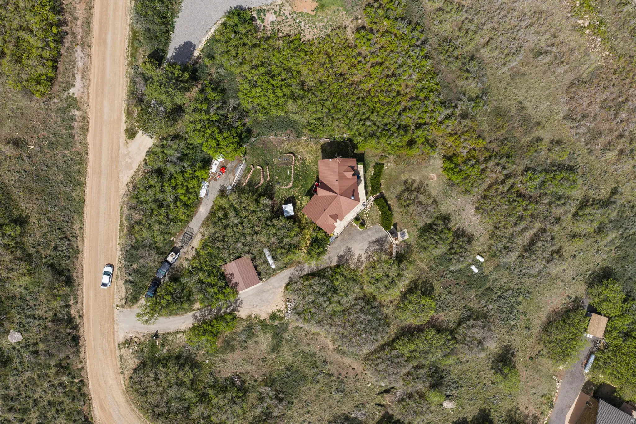 Aerial overview showcasing a secluded property with a main residence and an additional outbuilding