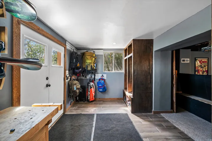 Entryway featuring wood-finish flooring and a built-in storage bench