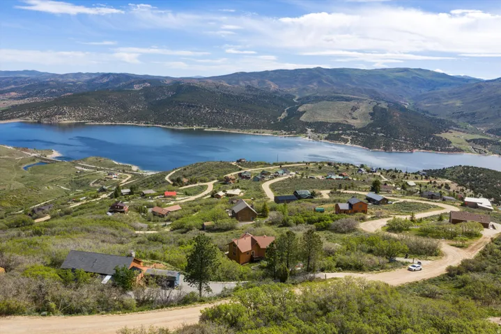 Aerial perspective showcasing a sprawling landscape with a prominent lake and surrounding mountains