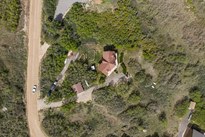 Aerial overview showcasing a secluded property with a main residence and an additional outbuilding