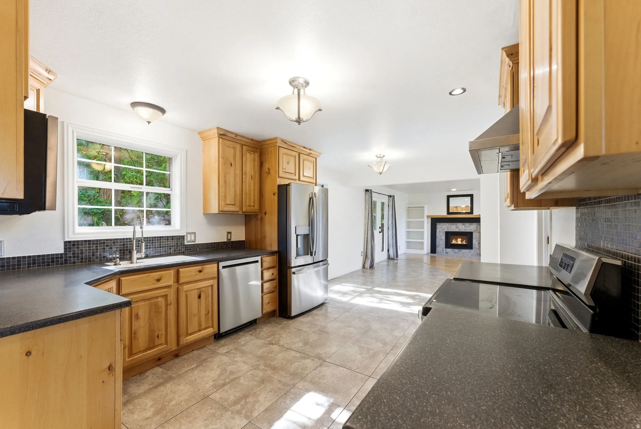 Kitchen featuring wood cabinetry, stainless steel appliances, solid surface countertops
