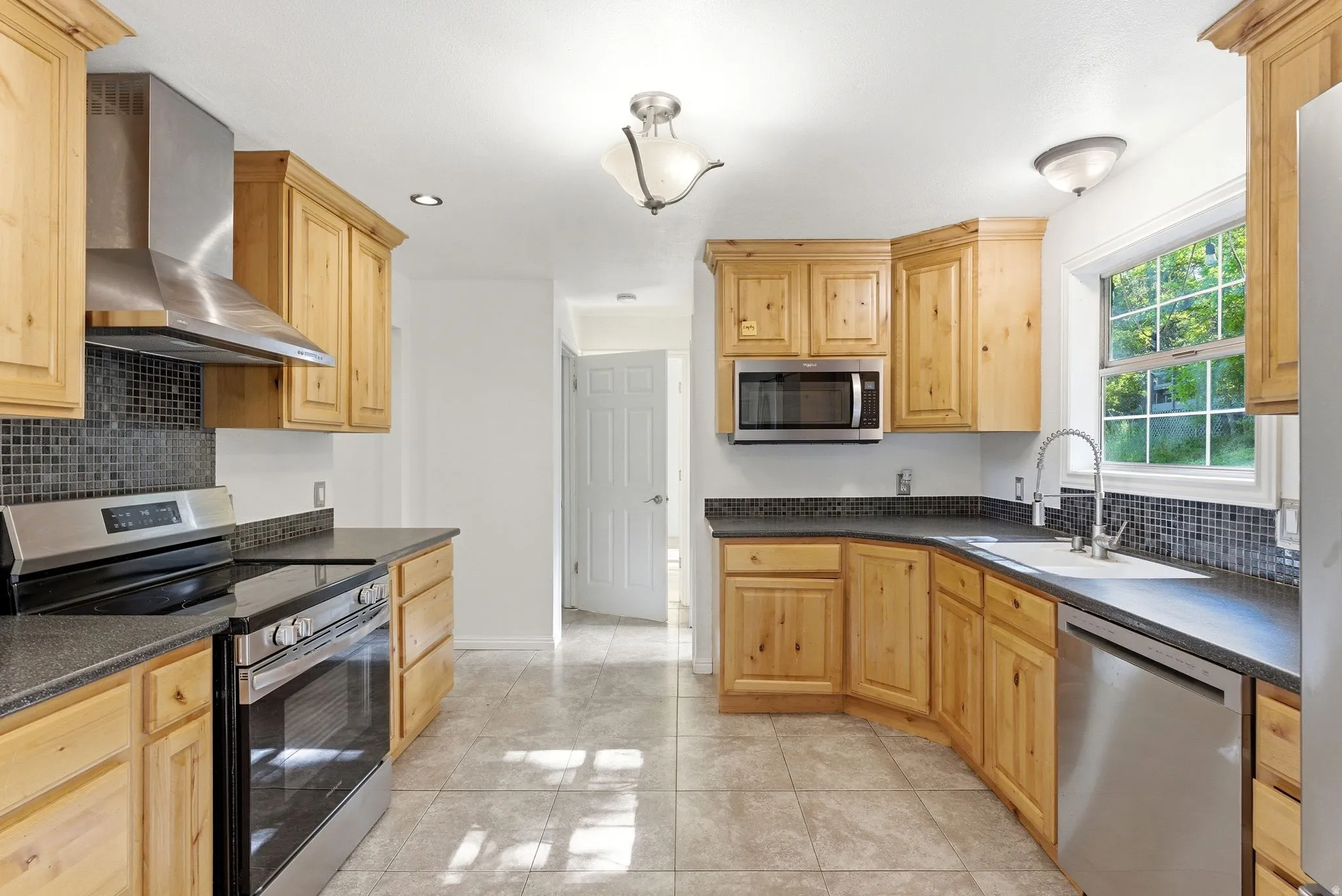 Kitchen featuring wood cabinetry, stainless steel appliances